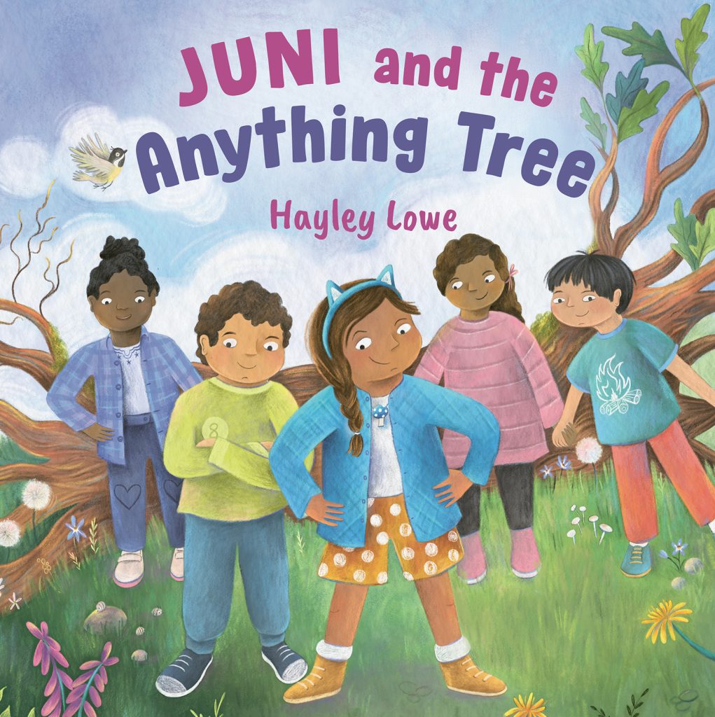 Juni and the Anything Tree by Hayley Lowe. Juni stands outside on a spring day, smiling confidently. Behind her stands Leo, also smiling. Three other school friends stand behind them supportively. In the background is a fallen tree with green leaves growing from its branches.